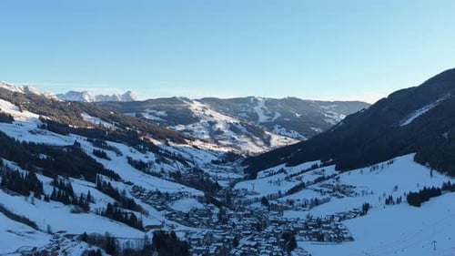 Static Aerial View Above Snowy Saalbach Village in Austrian Alps During Sunny Winter Day Showing