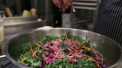Chef Preparing Salad with Kale and Shredded Vegetables