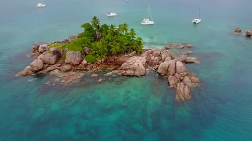 Boats anchor at beautiful St. Pierre island in the Seychelles.
