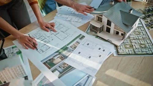 Architects Hands Pointing Blueprints Analyzing Building Model at Office Closeup