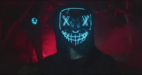 Demon with glowing mask in forest. Close Up