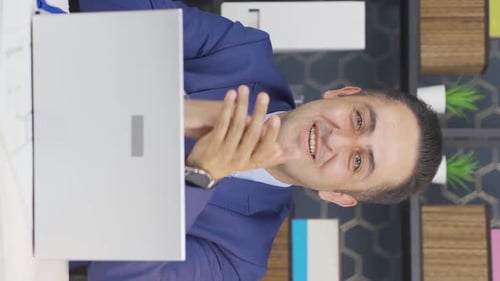 Smiling Man Claps and Gives Thumbs Up at Computer