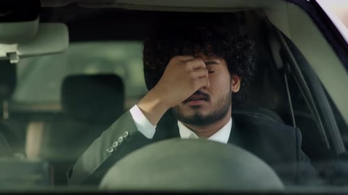 Man in Car Shows Stress and Sadness