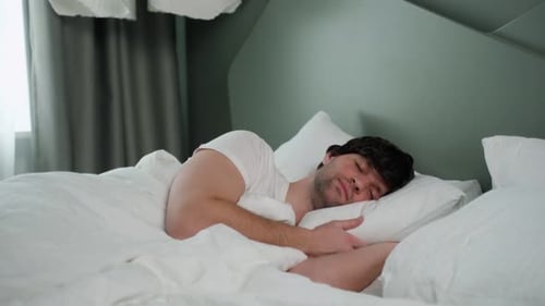 Man Sleeping Peacefully in Bed at Home
