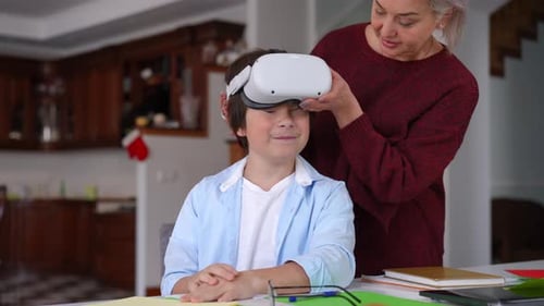 Boy Using VR Headset with Grandmother