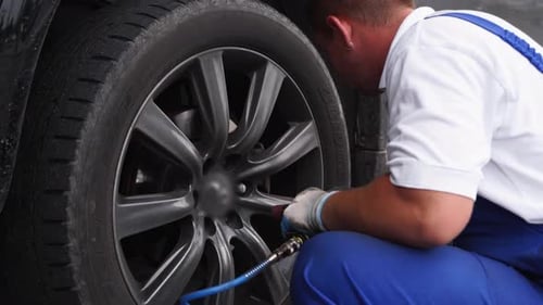 Auto Mechanic Uses Air Jack to Lift Car Efficiently Removing Tire with Pneumatic Nut Runner
