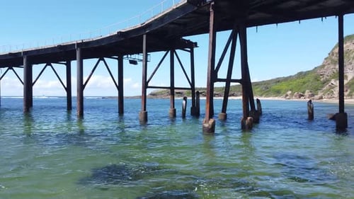 Aerial shot of old rugged ocean pier.