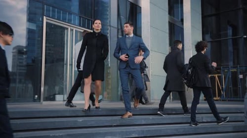 Female and Male are Talking and Smiling on Their Way from Office.