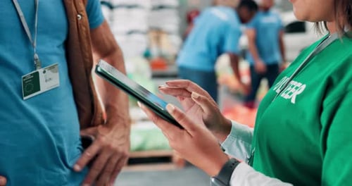People, hands or volunteer with tablet in warehouse for charity, helping or community service app