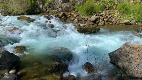 Waterfall flowing next to rocks in the forest