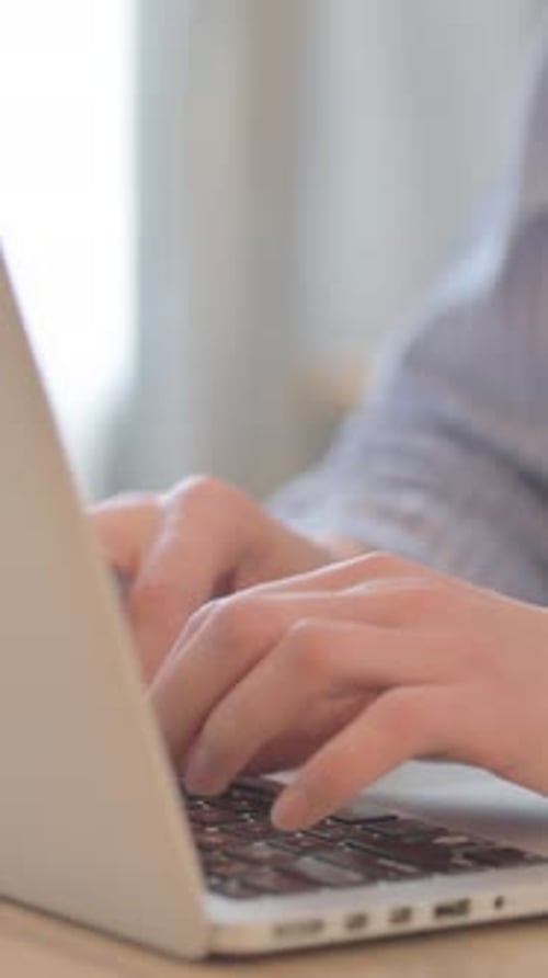 Close Up of Young Woman Typing on Laptop, vertical video