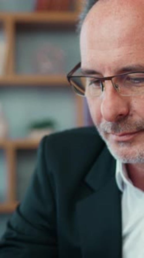 Adult Man Typing on Laptop Computer in Office