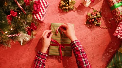 Friends Giving Presents to Each Other Top View Celebrating New Year Sitting at Dining Table