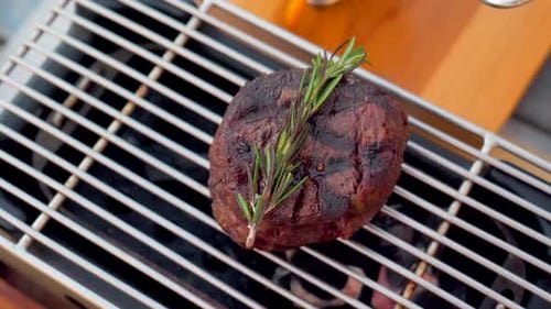 Aged Prime Beef Fillet Roasting on the Grill Seasoned with Herbs and Spices