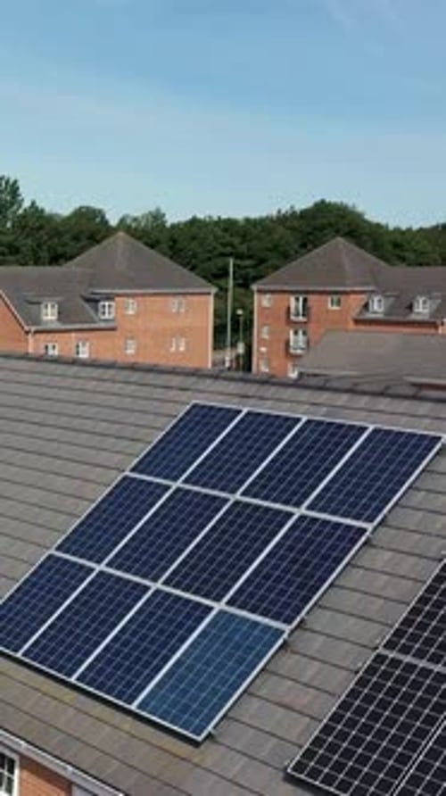 Vertical portrait aerial drone footage of a typical British newly built house with solar panels