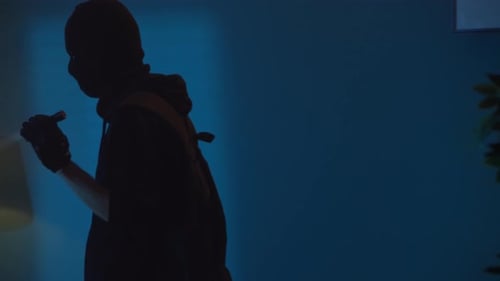 Masked Figures with Flashlights in Dark Home