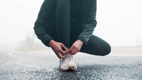 Fitness, shoes and hands tie laces in road for race, competition or marathon training with running