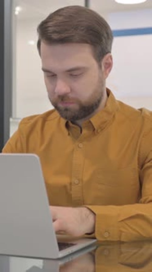 Casual Creative Man Working on Laptop in Office, Vertical Video