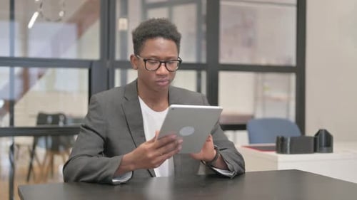 African American Man Using Digital Tablet in Office