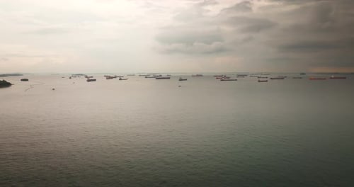 Container ships waiting in sea neat coast. Aerial drone lateral and copy space
