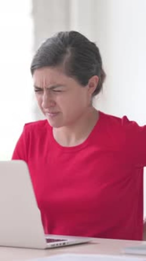 Indian Woman having Back Pain while using Laptop in Office, Vertical Video