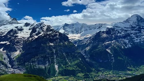 Panorama Of Bernese Alps And Swiss Village Grindelwald In Bern, Switzerland. wide panning shot