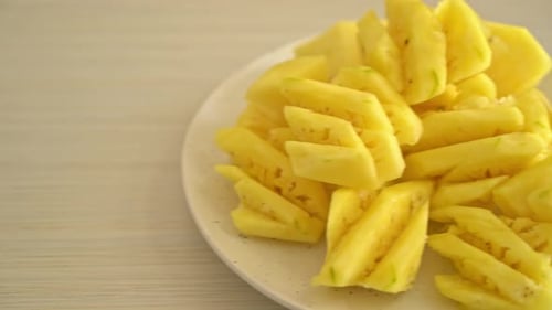 fresh pineapple sliced on plate