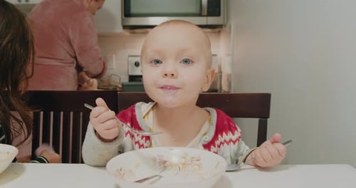 Infant eating at table at home