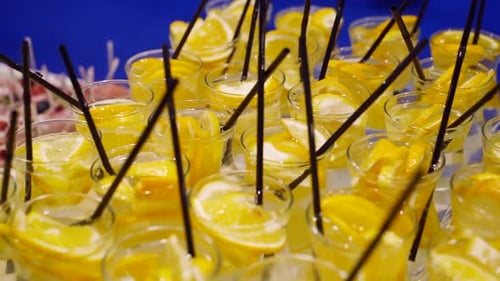 Glasses with Lemonade with Sliced Citrus Fruits on a Buffet Table on a Catering Food Service Summer