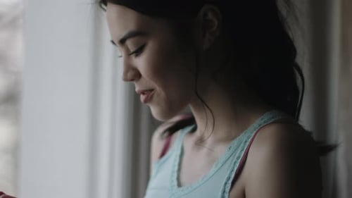 Woman Uses Smartphone in Apartment