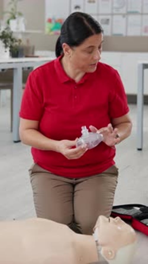 Breathing, CPR dummy and woman with resuscitation shield in office for demonstration