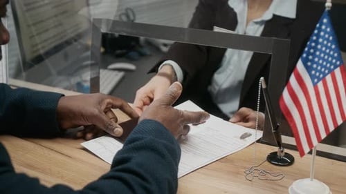 Mature Black Man Submitting Documents for American Visa at Consulate