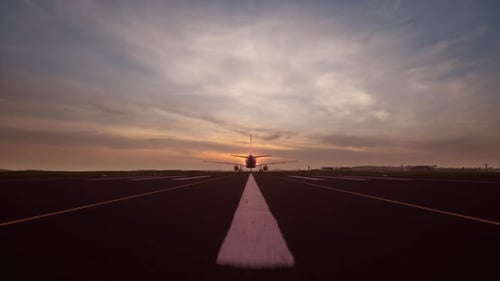 Airplane Approaching Landing on Runway at Sunset