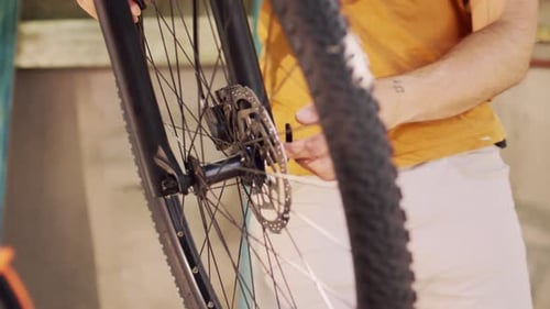 Mechanic Working on Bicycle Wheel Close Up