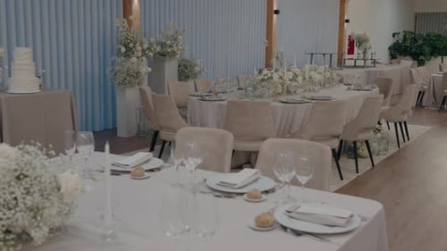 Elegant Wedding Reception Venue with Tables and White Flowers