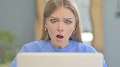 Close Up of Woman Reacting to Loss on Laptop