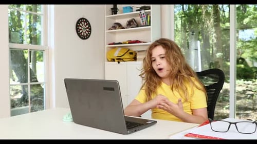 Kid Using Laptop for Online Studying at Home Child Sitting at Desk with Laptop on Virtual School