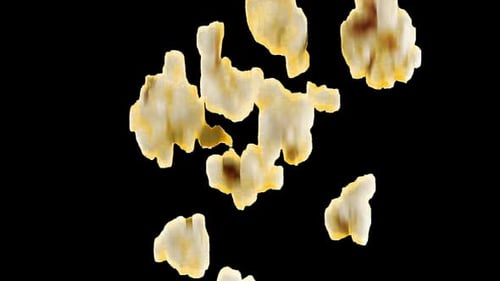 Popcorn grains falling. Slow motion. Alpha channel included.
