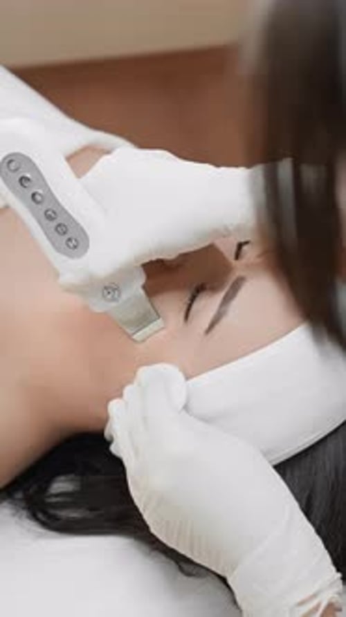 Woman Receiving Advanced Facial Treatment in Beauty Clinic