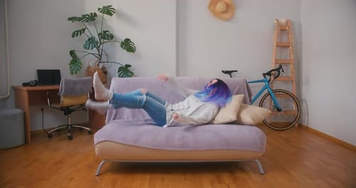 Sleepy Latin Hispanic Teenager Girl Exhausted or Bored Falls Down on Sofa Cozy Home Interior with