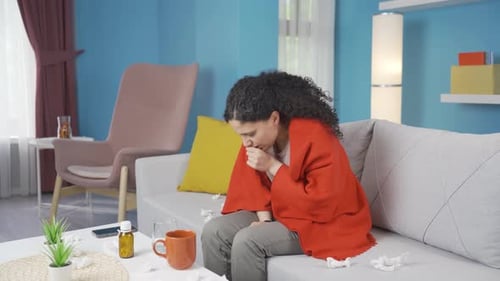 Ill Woman Coughing, Taking Medicine at Home