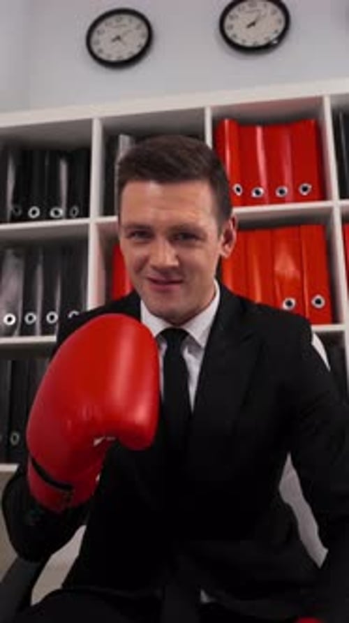 Vertical of Angry Aggressive Businessman with Boxing Gloves