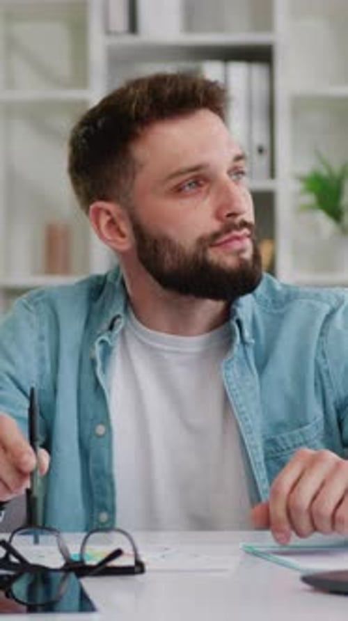 Thoughtful Man Sitting at Desk in Office