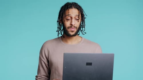 Happy Person Bonding with Mate Using Notebook to Hold Videoconference Studio