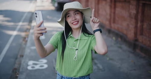 Woman Vlogging on Smart Phone in City Street