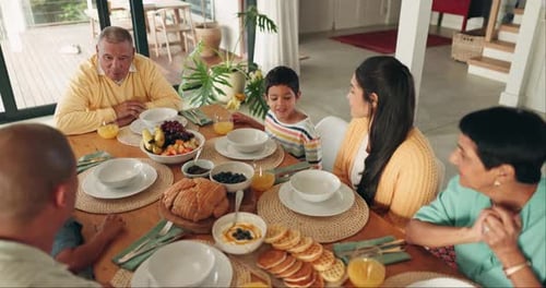 Family at the Breakfast Table at Home Talking