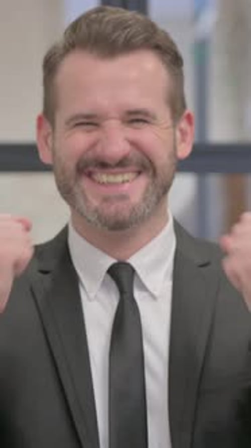 Excited Man Celebrating Success in Black Suit