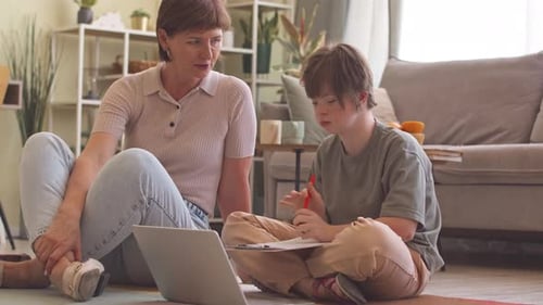 Woman and Child Studying Indoors at Home