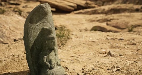 Ancient Stone Carving Discovered in an Arid Landscape During Daylight Hours