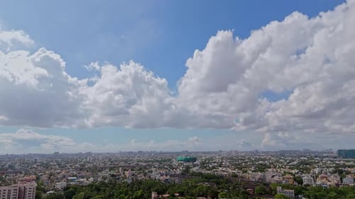 Expansive Cityscape Under Cloudy Blue Sky, Wide Shot